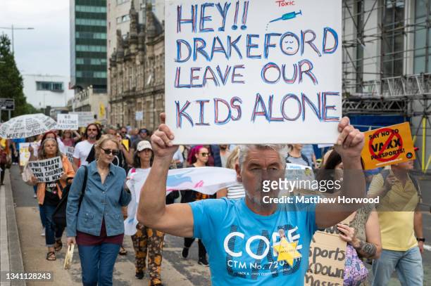 Protestors march through the city centre during a protest against vaccine passports on September 18, 2021 in Cardiff, Wales. First Minister of Wales...
