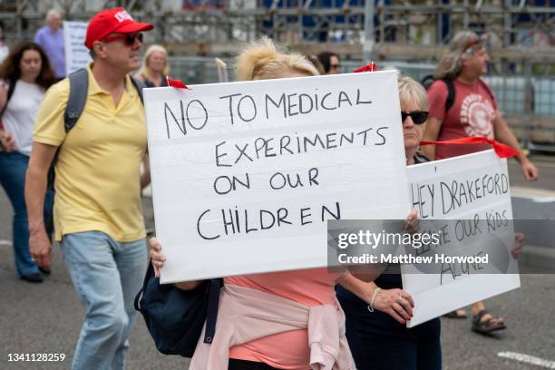 Protestor holds a sign which says “no to medical experiments on our children” during a protest on September 18, 2021 in Cardiff, Wales. First...