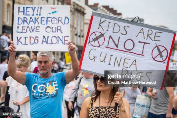 Protestors march through the city centre during a protest against vaccine passports on September 18, 2021 in Cardiff, Wales. First Minister of Wales...