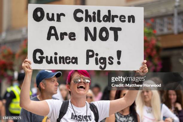 Person holds a sign which says “our children are not guinea pigs” during a protest against vaccine passports on September 18, 2021 in Cardiff, Wales....