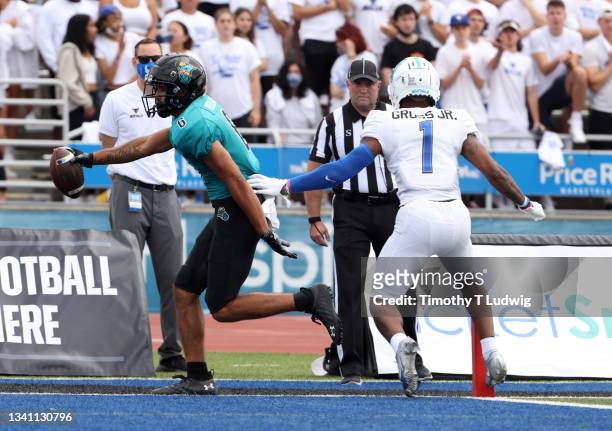Cory Gross Jr. #1 of the Buffalo Bulls watches as Jaivon Heiligh of the Coastal Carolina Chanticleers runs the ball in for a touchdown during the...