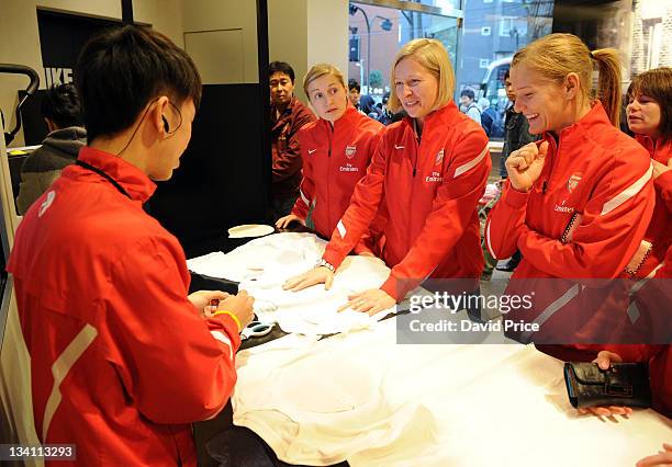 Ellen White, Jayne Ludlow and Katie Chapman of Arsenal Ladies FC during a visit to the Nike Store on November 26, 2011 in Tokyo, Japan.