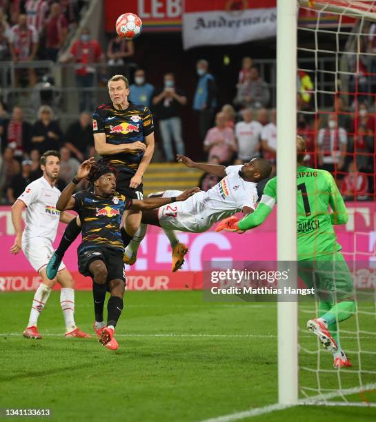 Anthony Modeste of 1. FC Köln tries to score against Lukas Klostermann , Mohamed Simakan and goalkeeper Peter Gulacsi of RB Leipzig during the...