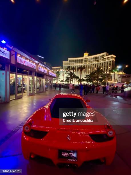 red ferrari parked on las vegas street, usa - bellagio las vegas stock pictures, royalty-free photos & images