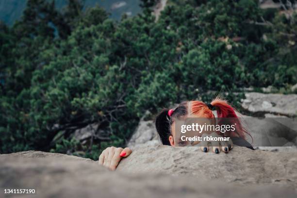 young rock climber gripping to a rock - cliff climb stock pictures, royalty-free photos & images