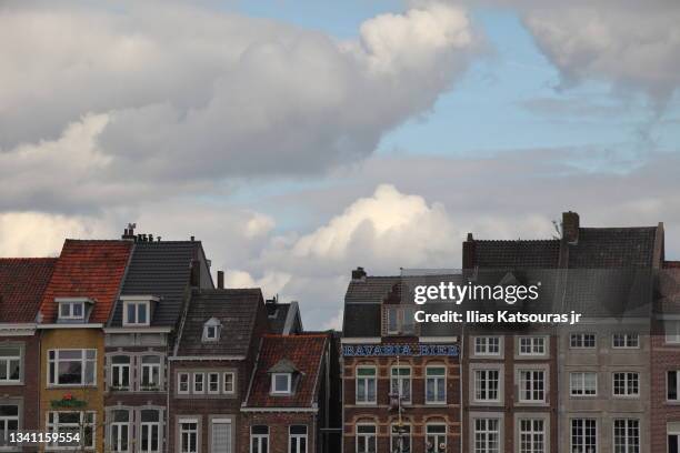 dutch houses against cloudy blue sky - years of the kingdom of the netherlands in maastricht stockfoto's en -beelden