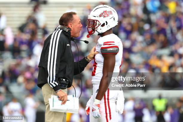 Head Coach Butch Jones of the Arkansas State Red Wolves has a conversation with Denzel Blackwell after a touchdown by the Washington Huskies during...