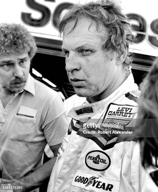 Driver Joe Ruttman is interviewed by the media after an accident took him out of the 1984 Daytona 500 race at Daytona International Speedway in...