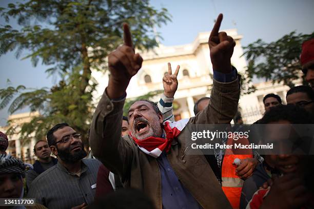 Protestors chant in front of the parliament building as they support a sit-in at the nearby cabinet office on November 26, 2011 in Cairo, Egypt....