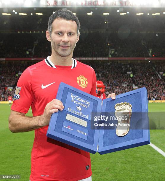 Ryan Giggs of Manchester United poses with a Golden Foot award ahead of the Barclays Premier League match between Manchester United and Newcastle...