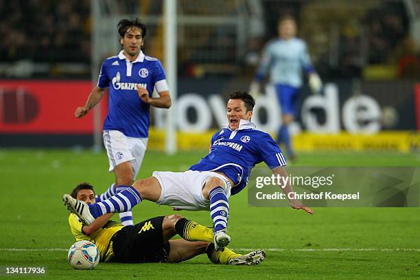 Alexander Baumjohann of Schalke falls over Sebastian Kehl of Dortmund during the Bundesliga match between Borussia Dortmund and FC Schalke 04 at...