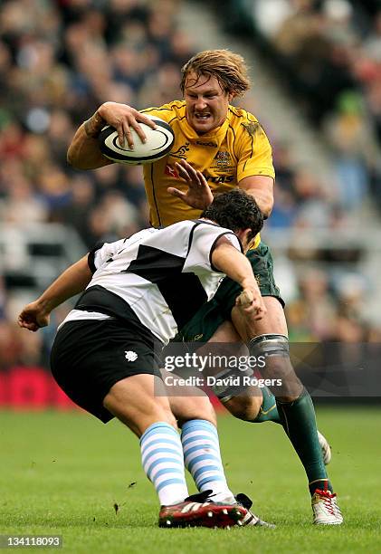 Scott Higginbotham of The Wallabies is tackled by Eusebio Guinazu of the Barbarians during the Killik Cup match between the Barbarians and Australia...