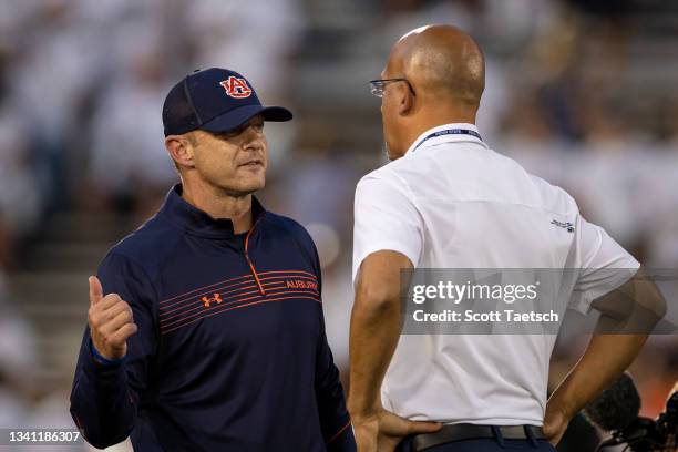 Head coach Bryan Harsin of the Auburn Tigers speaks with head coach James Franklin of the Penn State Nittany Lions before the game at Beaver Stadium...