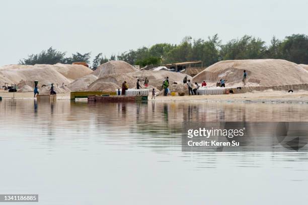 harvested salt piles on lake retba (pink lake) - lake retba stock pictures, royalty-free photos & images