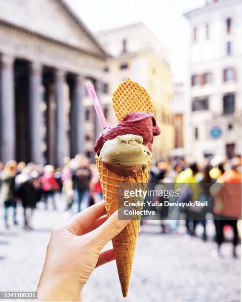 A woman is holding gelato ice cream waffle cone in Pantheon, Rome