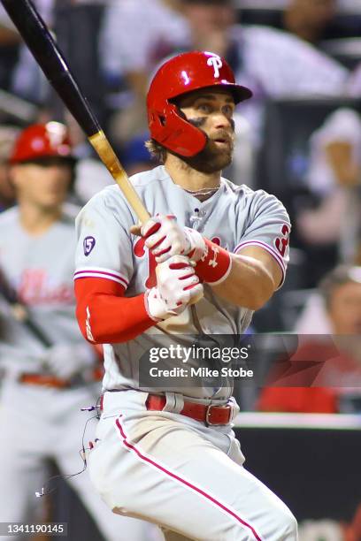 Bryce Harper of the Philadelphia Phillies hits a two-run double in the seventh inning against the New York Mets at Citi Field on September 18, 2021...