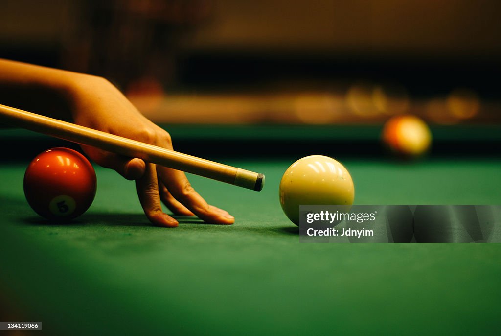 Woman hand playing pool