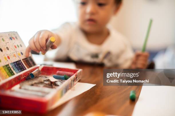 a baby boy's hand holding a crayon - crayons stock pictures, royalty-free photos & images