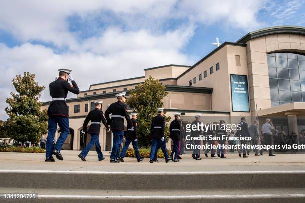 Service members with the U.S. Marine Corps march toward Bayside Church Adventure Campus ahead of a public memorial service for Marine Corps Sgt....