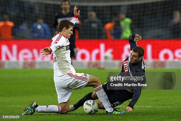 Pierre Michael Lasogga of Berlin and Daniel Schwaab of Leverkusen battle for the ball during the Bundesliga match between Hertha BSC Berlin and Bayer...