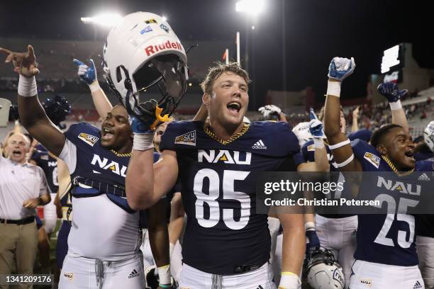 Tight end Matthew Kempton of the Northern Arizona Lumberjacks celebrates with teammates after defeating the Arizona Wildcats in the NCCAF game at...