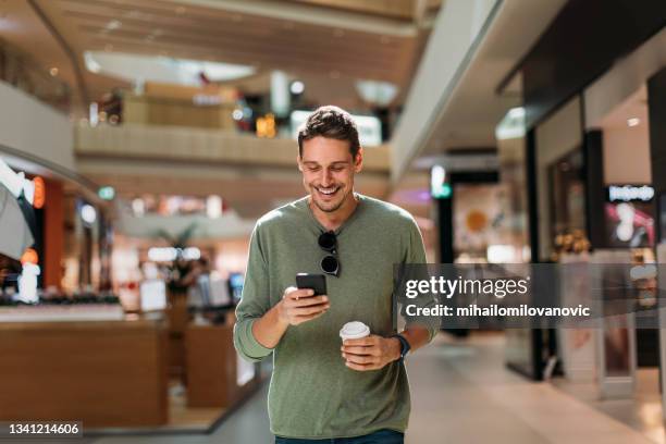 portrait of man using phone - shopping mall stock pictures, royalty-free photos & images