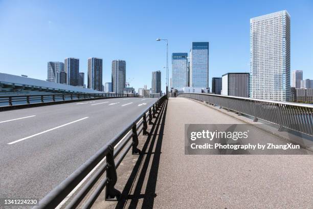 tokyo city street low angle view in harumi, chuo ward, japan at day time. - chuo ward tokyo stockfoto's en -beelden