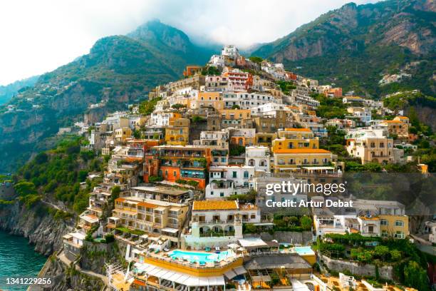 aerial view of the colorful positano town with scenic road in the amalfi coast of italy. - mezzogiorno stock-fotos und bilder