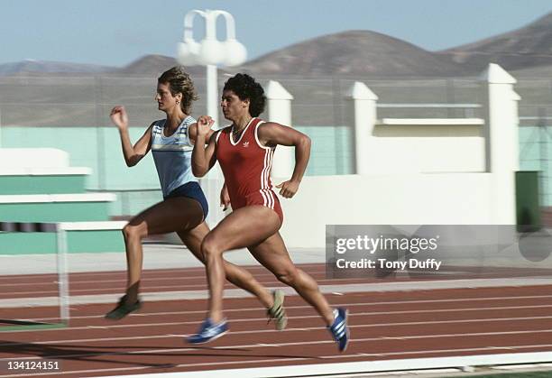 Fatima Whitbread of Great Britain runs with Donna Hartley during training on 1st February 1984 at the British Olympic training camp in La Santa,...