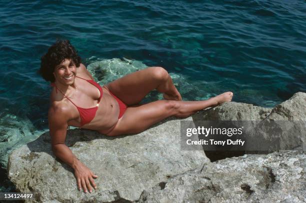 Fatima Whitbread of Great Britain relaxes in a bikini by the sea during training on 10th March 1983 in Limassol, Cyprus.