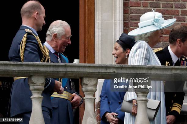 Prince Charles, Prince of Wales speaks with Home Secretary, Priti Patel as they stand on the balcony of Church House after the Battle of Britain 81st...