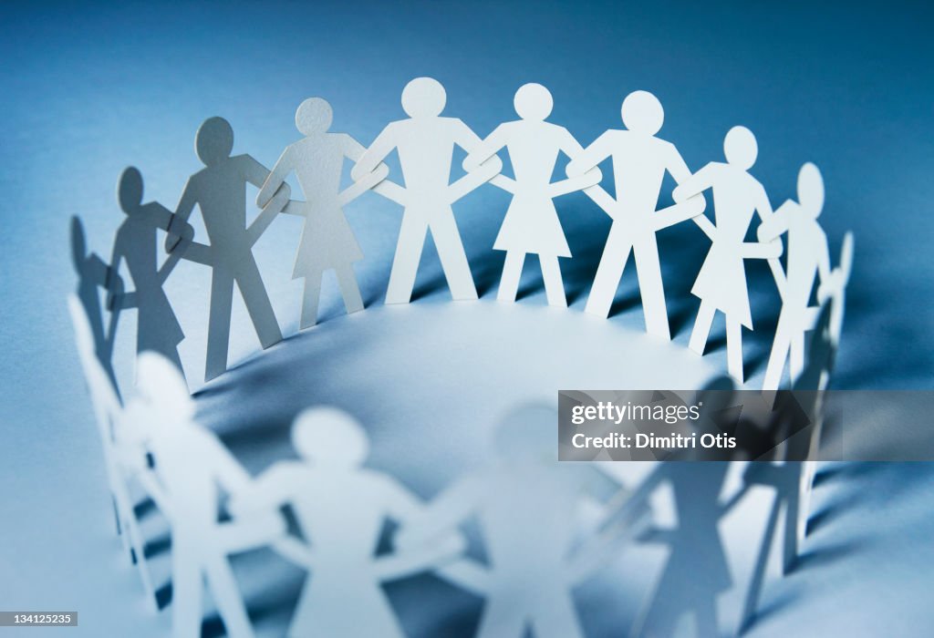 Circle of interlinked paper cut-out men and woman