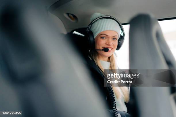 woman sitting in helicopter wearing headset - helicopter pilot stock pictures, royalty-free photos & images