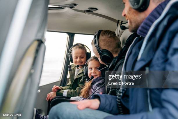 kids having fun while traveling by a chopper - helicopter ride stock pictures, royalty-free photos & images