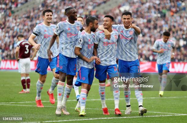 Jesse Lingard of Manchester United celebrates with Aaron Wan-Bissaka, Bruno Fernandes and Cristiano Ronaldo after scoring their team's second goal...