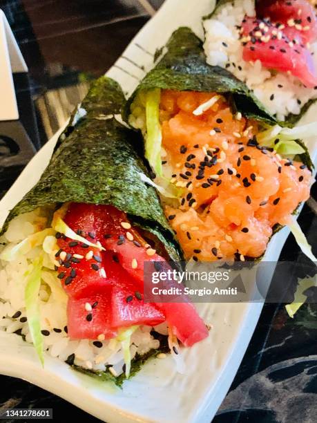 sushi hand rolls - hand roll stock pictures, royalty-free photos & images