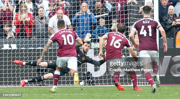 David de Gea of Manchester United saves a penalty from Mark Noble of West Ham United during the Premier League match between West Ham United and...