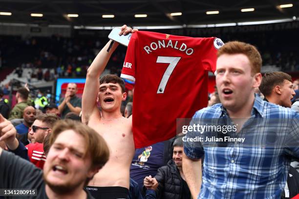 Manchester United fan holds a Cristiano Ronaldo shirt after their sides victory in the Premier League match between West Ham United and Manchester...