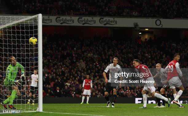 Thomas Vermaelen of Arsenal scores their first goal past Mark Schwarzer of Fulham during the Barclays Premier League match between Arsenal and Fulham...