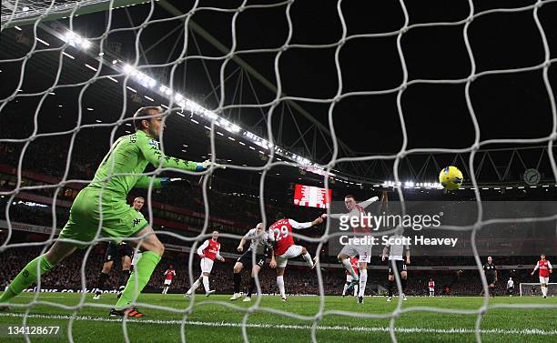 Thomas Vermaelen of Arsenal scores their first goal past Mark Schwarzer of Fulham during the Barclays Premier League match between Arsenal and Fulham...