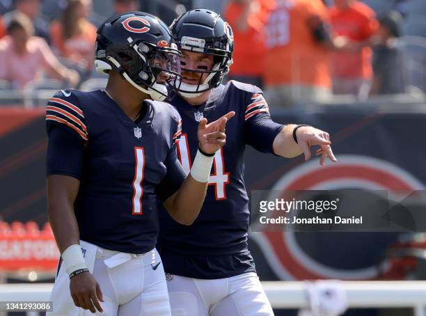 Quarterback Justin Fields talks with Quarterback Andy Dalton of the Chicago Bears talks before the game against the Cincinnati Bengals at Soldier...