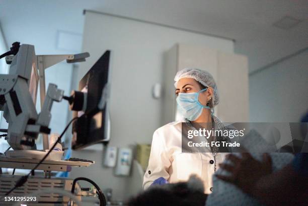 doctor examining patient with endoscope - endoscope stock pictures, royalty-free photos & images