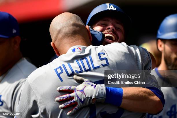 Gavin Lux of the Los Angeles Dodgers hugs Albert Pujols after hitting a two-run home run in the second inning during their game against the...