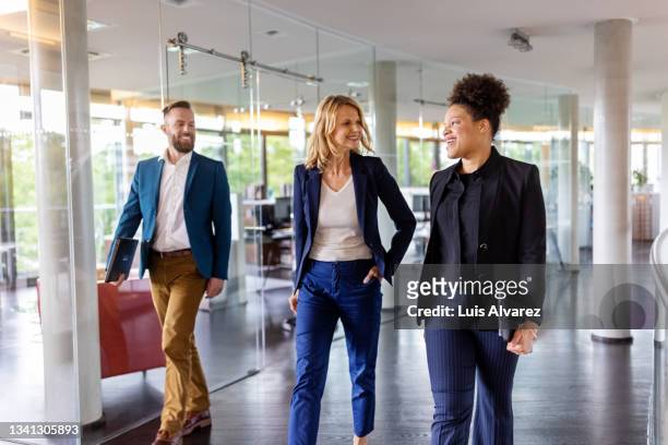 team of corporate professionals moving through the office corridor - business walking stockfoto's en -beelden