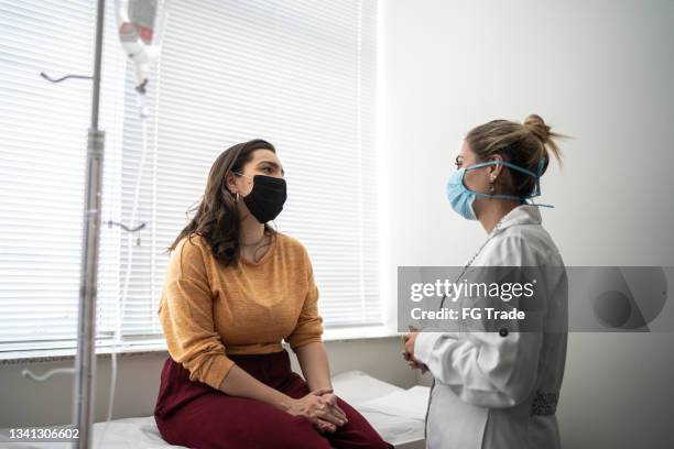 paciente que habla con el médico en la cita médica - usando máscara facial protectora - examination room fotografías e imágenes de stock