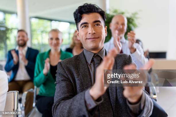 corporate professionals applauding in a seminar - corporate awards ceremony stock pictures, royalty-free photos & images