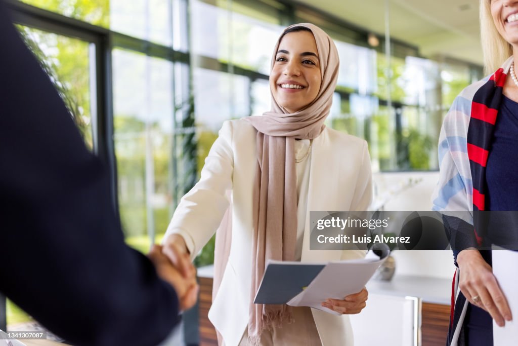 Muslim businesswomen sealing a deal with a handshake