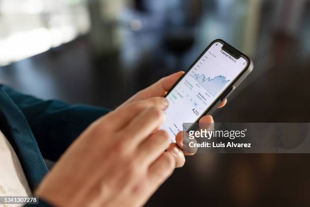 close-up of male professional hands using mobile phone - trading ストックフォトと画像