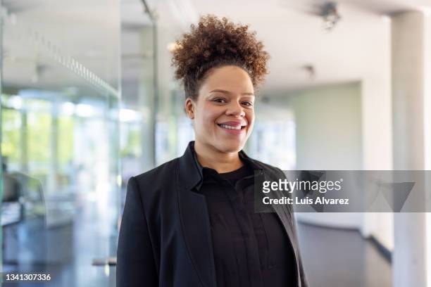 portrait of a female corporate professional in office - black suit stock-fotos und bilder
