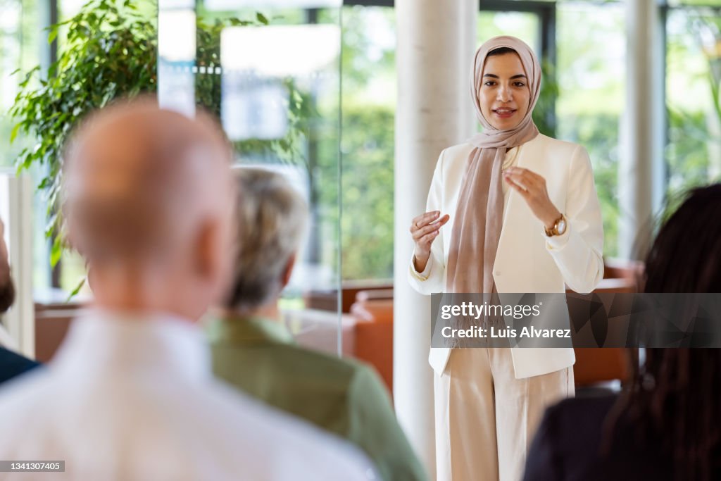 Muslim businesswoman addressing the audience in a conference